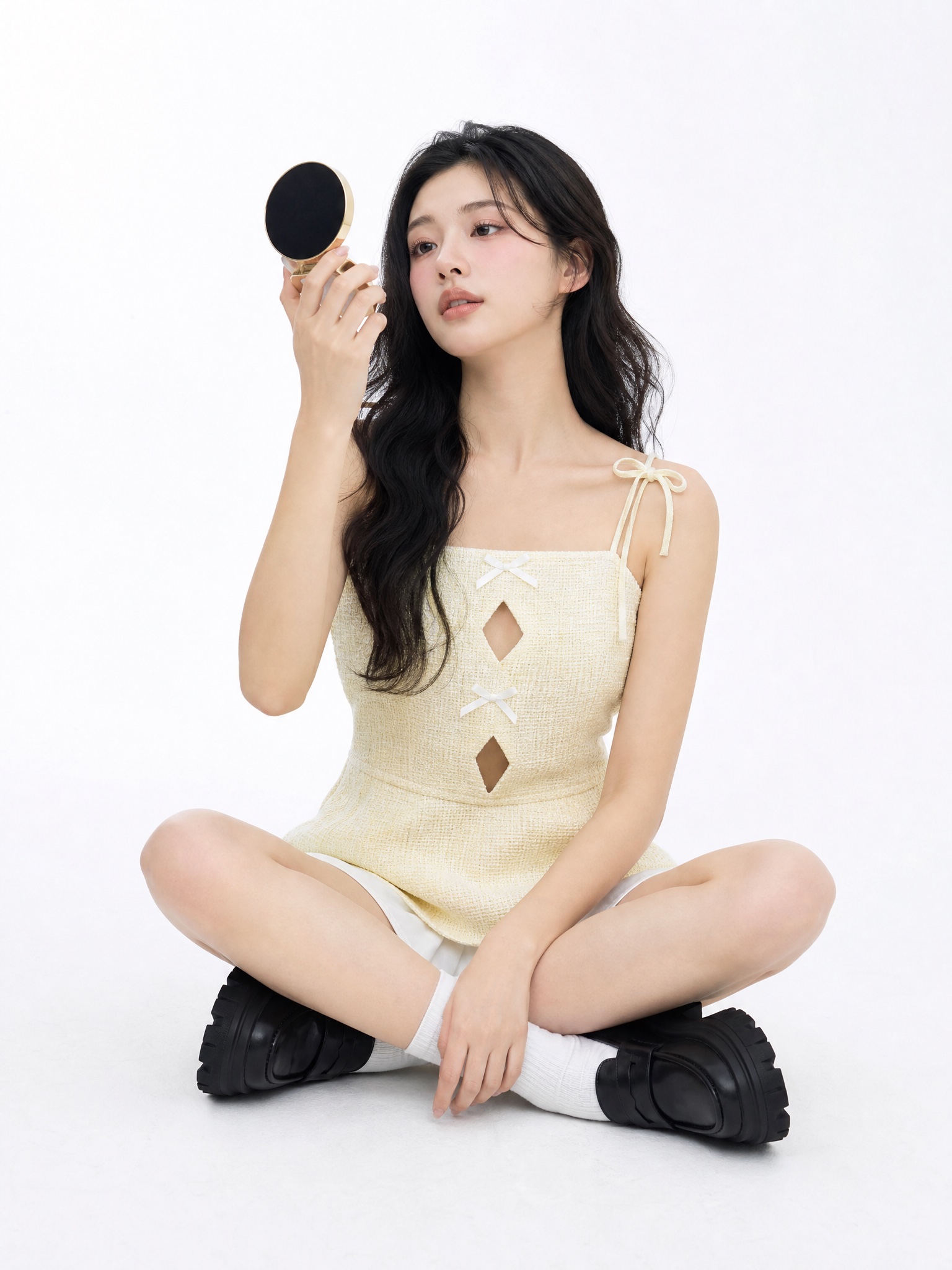 Clothes swapper AI before — yellow bow top sitting with compact mirror, white studio